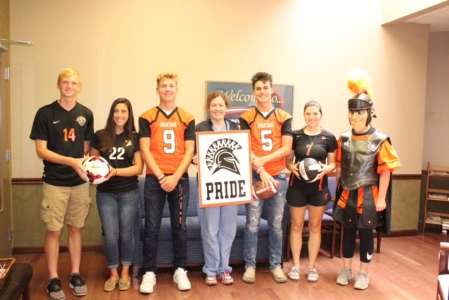 people wearing jerseys and holding sign